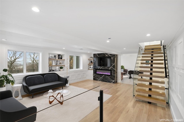 living room featuring a fireplace and light wood-type flooring