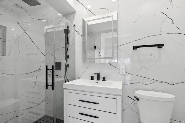 bathroom with vanity, backsplash, toilet, tile walls, and walk in shower