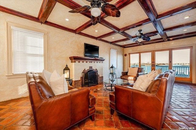 living room featuring ceiling fan, beamed ceiling, and coffered ceiling