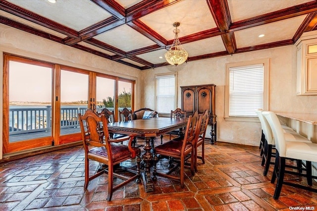 dining area featuring beam ceiling, a wealth of natural light, and coffered ceiling