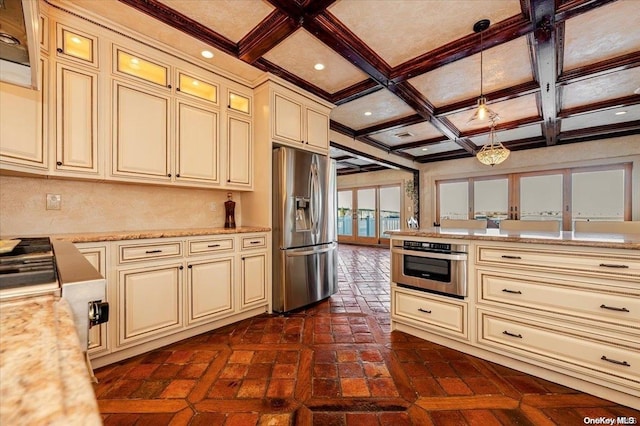 kitchen featuring coffered ceiling, hanging light fixtures, appliances with stainless steel finishes, and cream cabinets