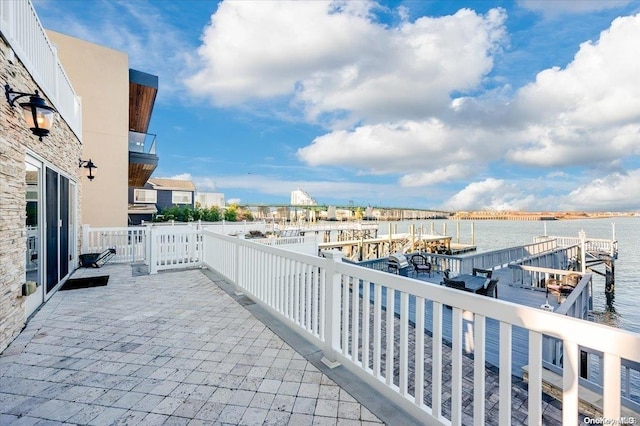 view of patio / terrace featuring a boat dock and a water view