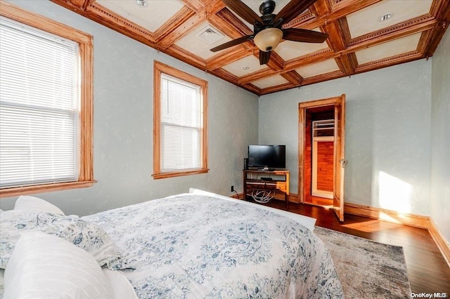 bedroom with beam ceiling, wood-type flooring, and coffered ceiling