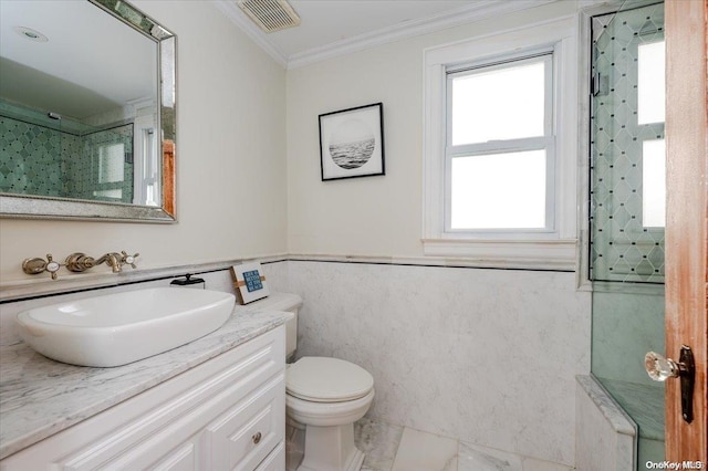 bathroom featuring a shower, vanity, toilet, and ornamental molding