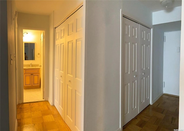 hallway with sink and light parquet floors