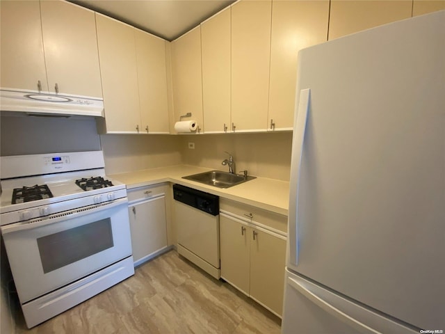 kitchen featuring sink, white cabinets, white appliances, and light wood-type flooring