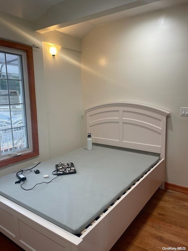 bedroom with dark hardwood / wood-style flooring and vaulted ceiling