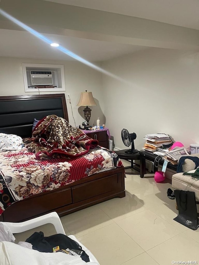 bedroom with a wall mounted air conditioner and light tile patterned floors