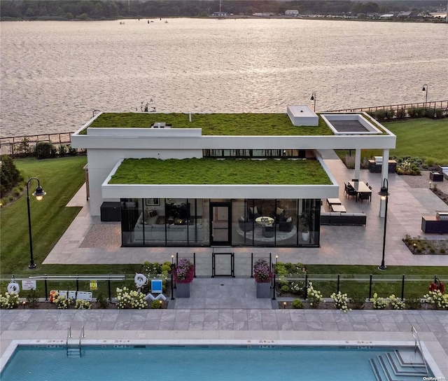 rear view of house featuring a community pool and a patio area