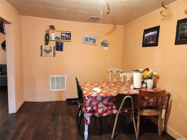 dining room featuring crown molding and dark hardwood / wood-style flooring