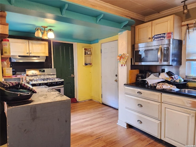 kitchen featuring light wood-type flooring, white range with gas cooktop, and ornamental molding