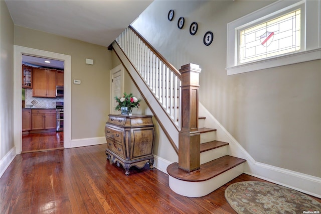 stairs featuring hardwood / wood-style flooring