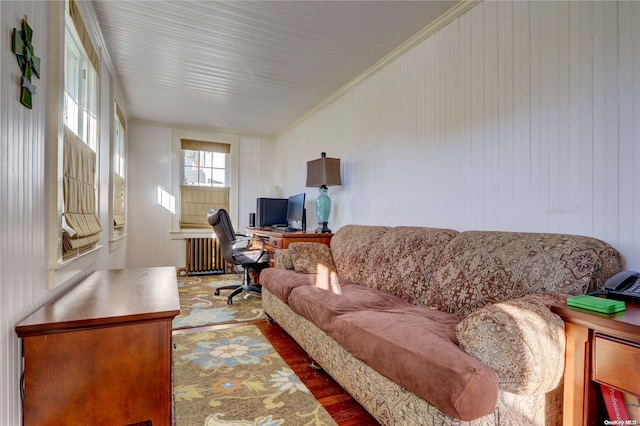 living room with radiator, hardwood / wood-style flooring, vaulted ceiling, and ornamental molding