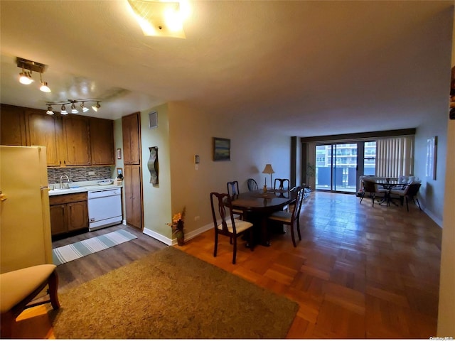 kitchen with dishwasher, fridge, sink, tasteful backsplash, and rail lighting