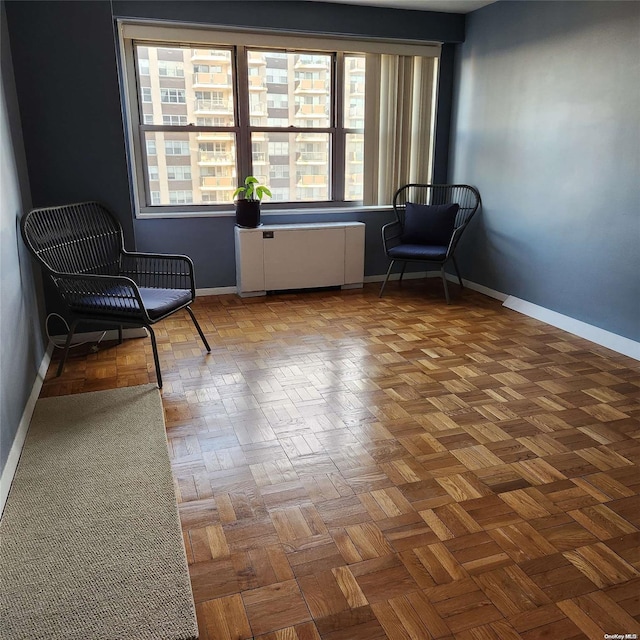 unfurnished room featuring radiator heating unit and parquet floors