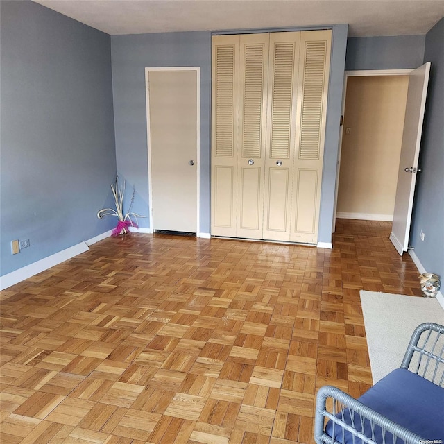 unfurnished bedroom with light parquet floors and a closet