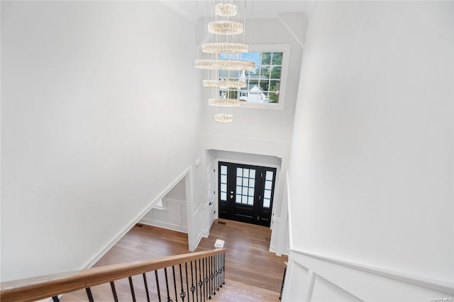 foyer featuring hardwood / wood-style flooring and a chandelier