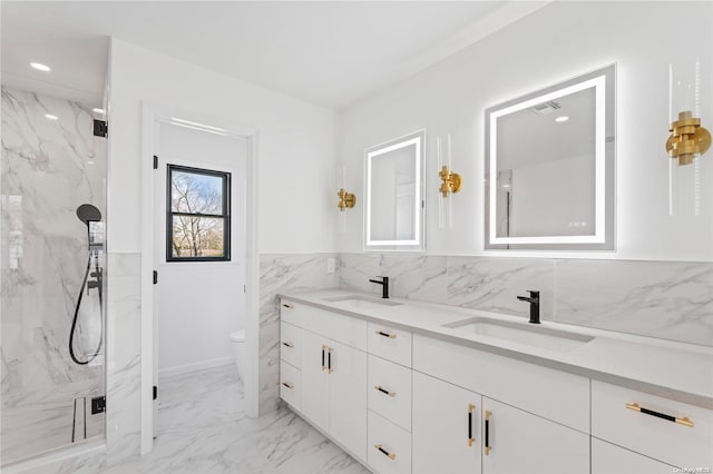 bathroom featuring vanity, a shower with shower door, and toilet