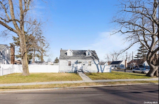 cape cod home featuring a front lawn