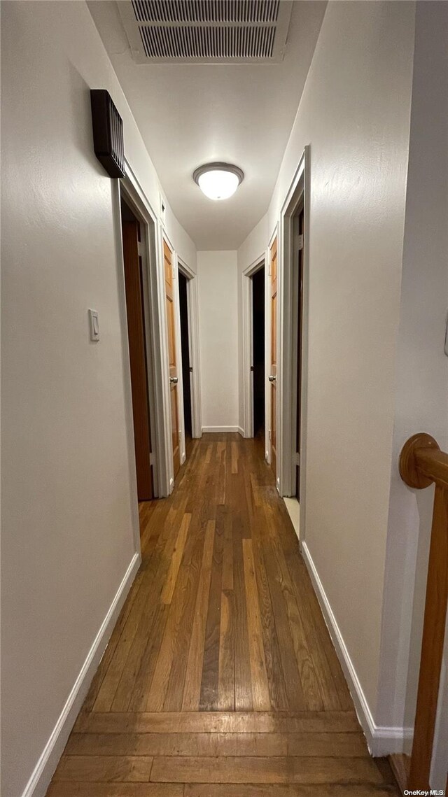 hallway featuring dark hardwood / wood-style floors