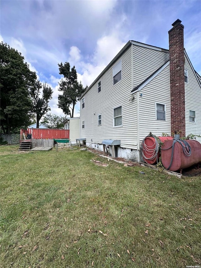 rear view of property featuring a lawn