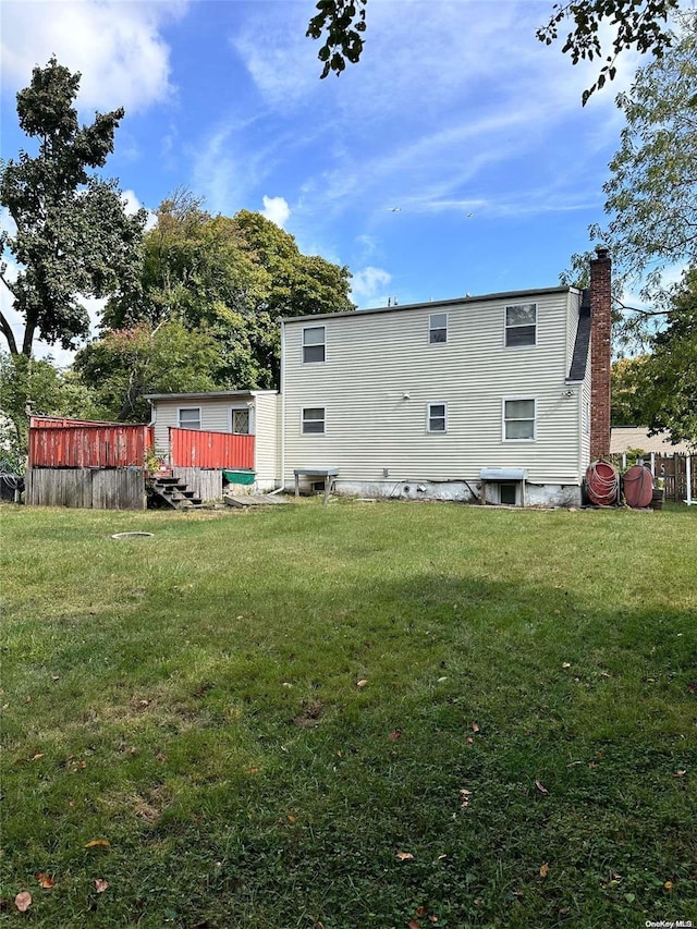 rear view of house with a lawn