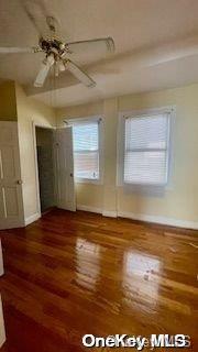 empty room featuring ceiling fan and dark hardwood / wood-style flooring