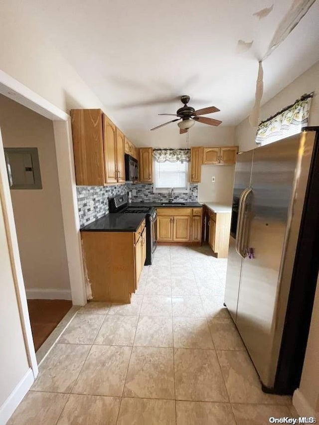 kitchen featuring electric panel, sink, ceiling fan, decorative backsplash, and appliances with stainless steel finishes