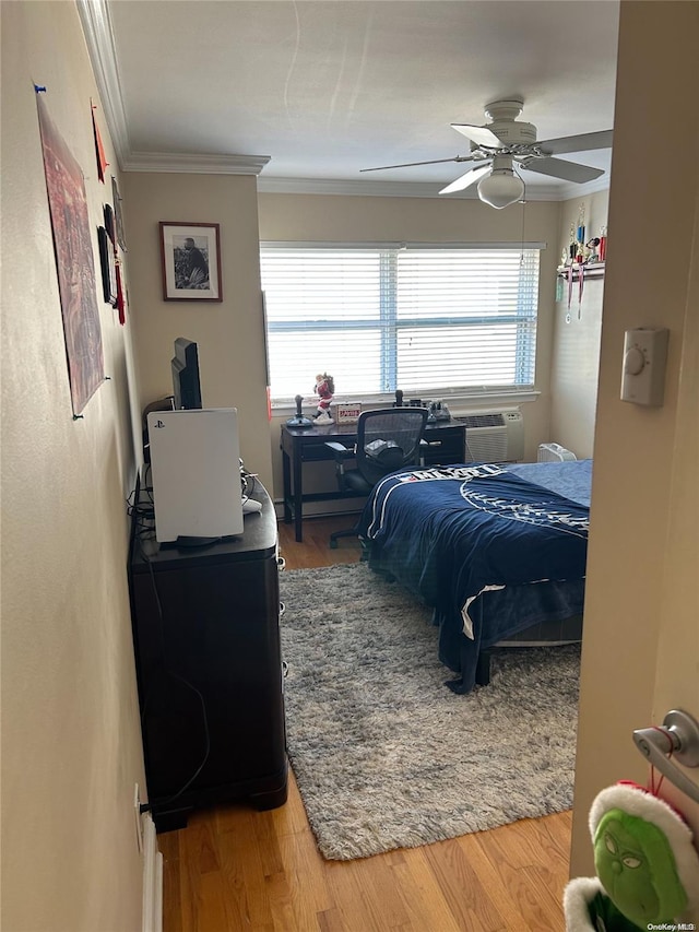 bedroom with hardwood / wood-style flooring, multiple windows, crown molding, and ceiling fan