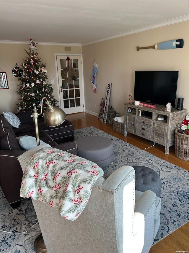 living room with ornamental molding and hardwood / wood-style flooring