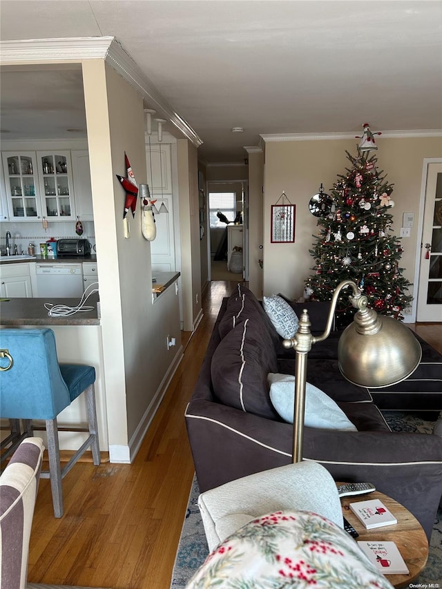 interior space with crown molding, hardwood / wood-style floors, and sink