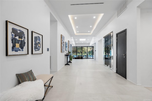 corridor featuring a tray ceiling