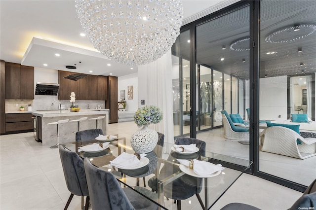 dining area featuring light tile patterned flooring, sink, and an inviting chandelier