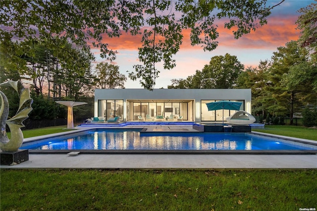 view of pool at dusk