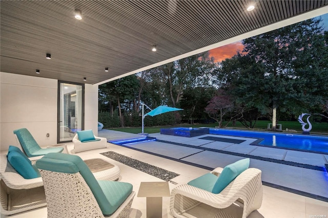 view of patio / terrace featuring a pool with hot tub