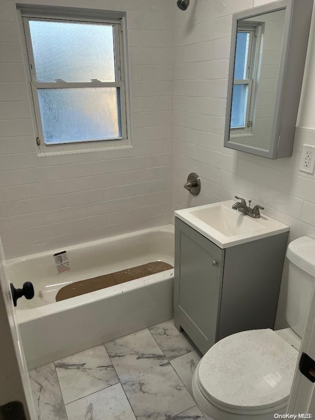 full bathroom with vanity, backsplash, tiled shower / bath, toilet, and tile walls