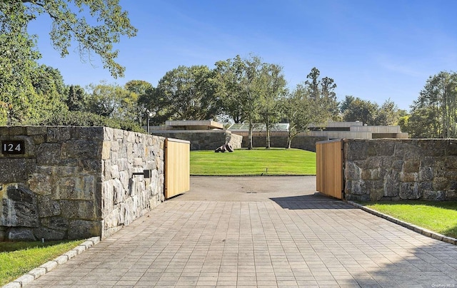 view of gate featuring a lawn