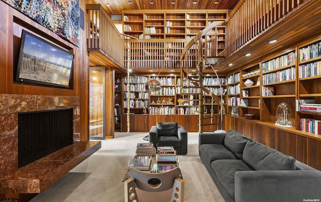 carpeted living room featuring a towering ceiling and wood ceiling