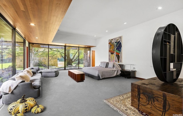 carpeted bedroom with floor to ceiling windows and wood ceiling