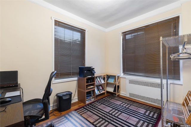 home office with crown molding, radiator heating unit, and wood-type flooring