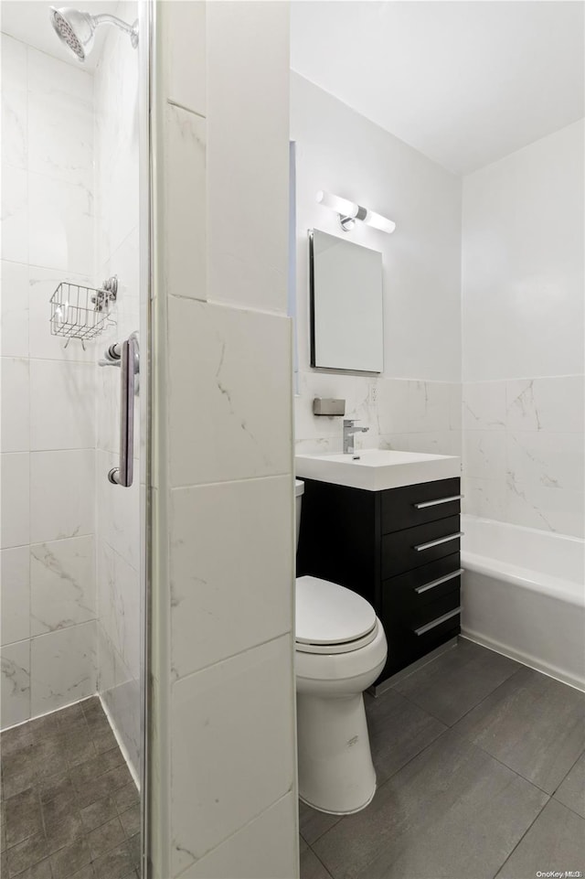 bathroom with vanity, toilet, and tiled shower