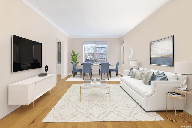 living room featuring light hardwood / wood-style floors and crown molding