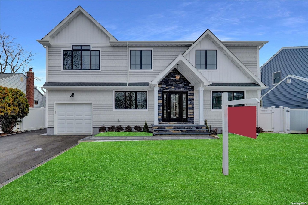 view of front of property with a front lawn and a garage