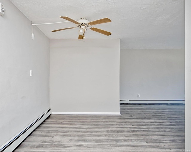 222 Smith St Unit 3C, Freeport, NY 11520 - unfurnished room featuring baseboard heating, wood finished floors, a textured ceiling, ceiling fan, and baseboards