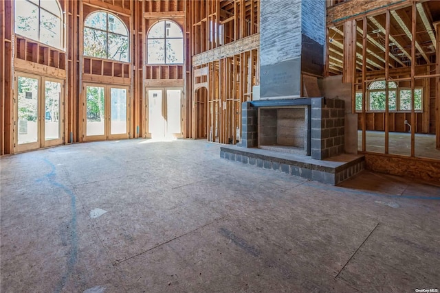 unfurnished living room featuring a high ceiling