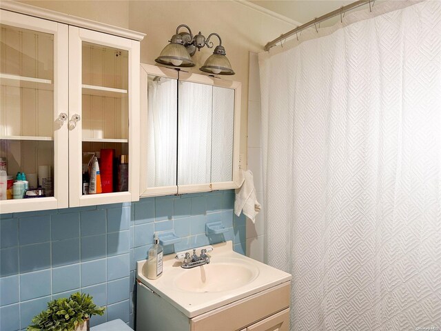 26-44 92nd St, Flushing, NY 11369 - bathroom with a shower with shower curtain, vanity, and tile walls