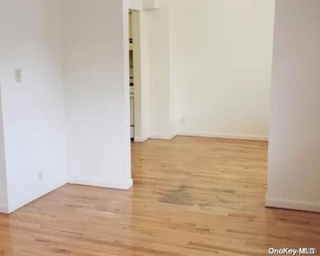 unfurnished room with wood-type flooring