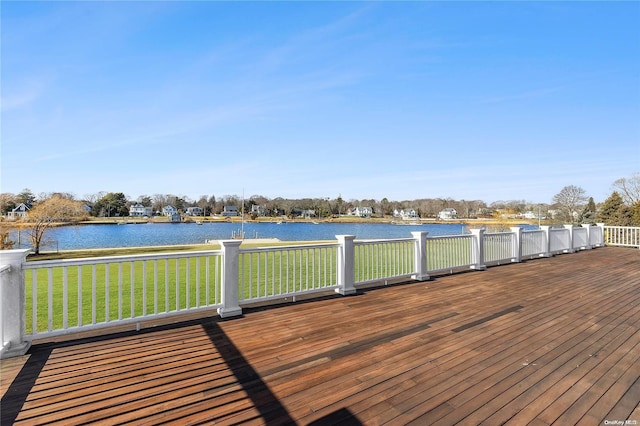 wooden terrace featuring a water view