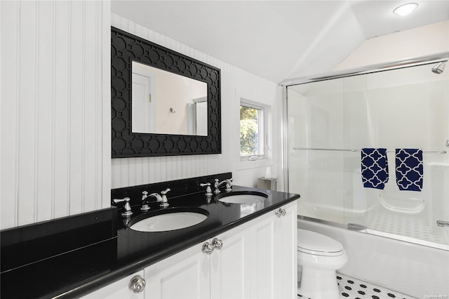 full bathroom featuring tile patterned flooring, enclosed tub / shower combo, vaulted ceiling, toilet, and vanity