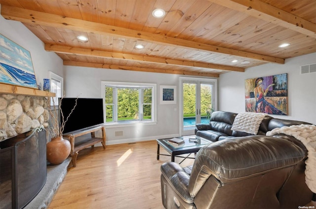 living room featuring beam ceiling, light hardwood / wood-style floors, french doors, and wood ceiling